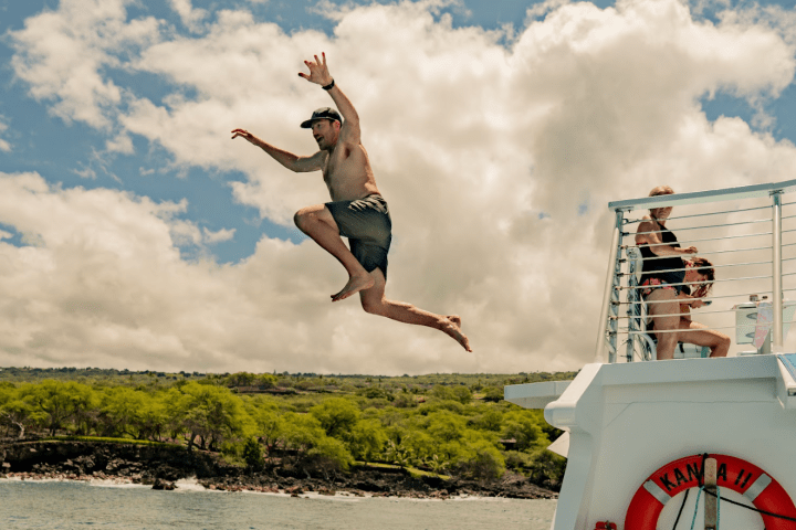 Someone jumping off the high jump on Body Glove Cruises