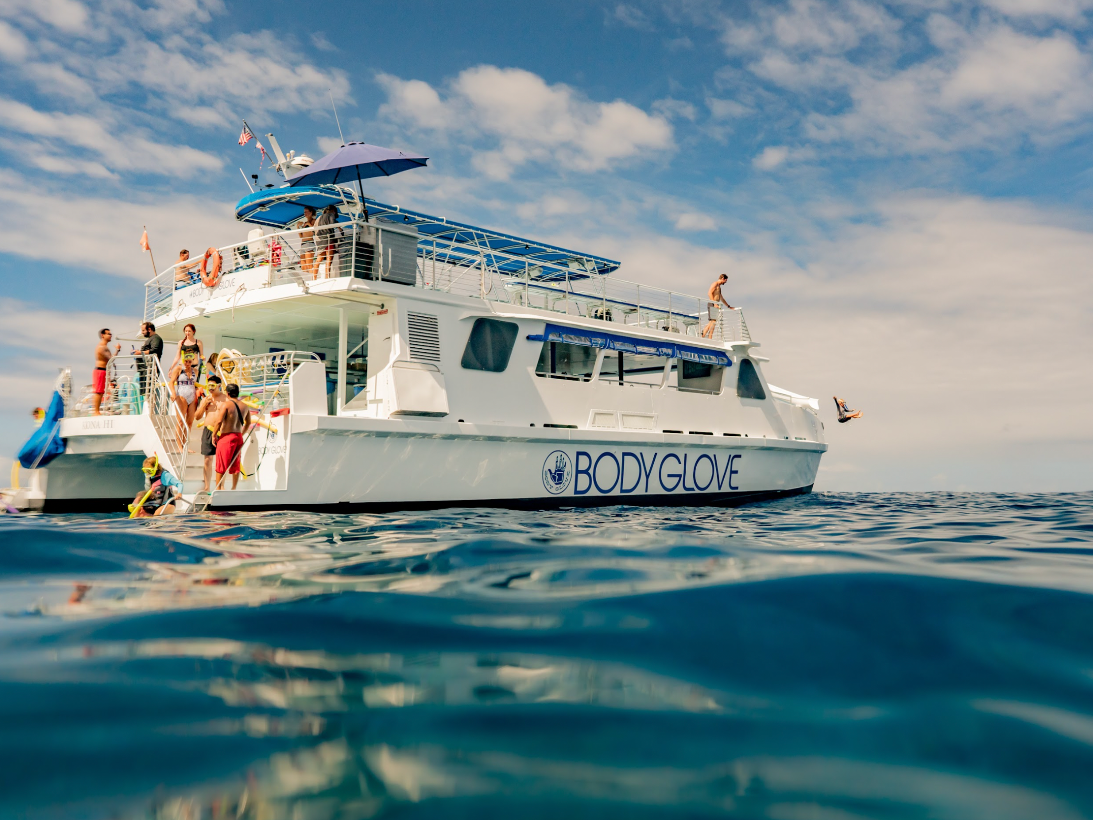 view of a body glove deluxe snorkel and dolphin watch boat from the water