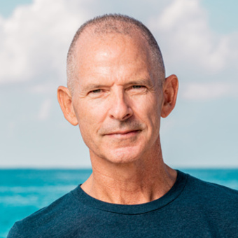 a man standing next to a body of water