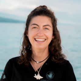 a person standing next to a body of water