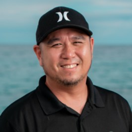 a man standing in front of a body of water