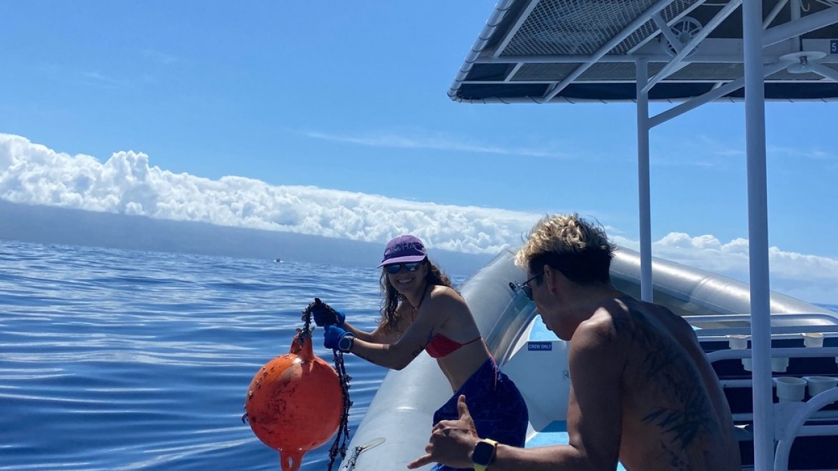 a man standing next to a boat