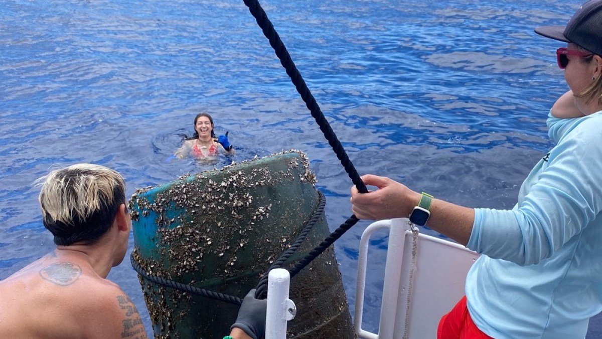 a man and a woman standing next to a body of water