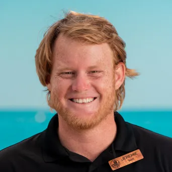 a man standing in front of a body of water