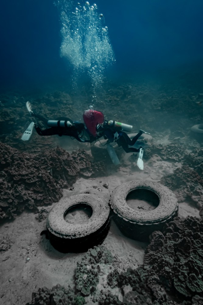 divers work to remove tires underwater