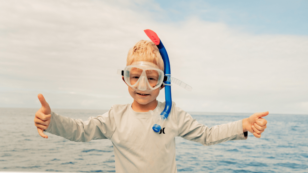 young boy ready to snorkel at a family friendly beach on the big island